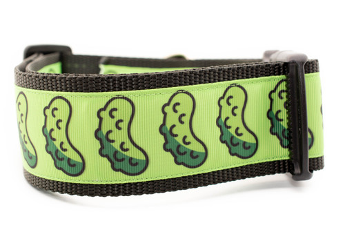 Dog collar with bright lime green ribbon with a repeating pickle pattern sewn onto 2 inch wide black nylon webbing.