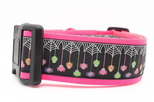Spiderweb design with dangling spiders on neon pink nylon.
