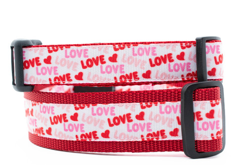 Collar with "Love" in red, pink, and fuchsia on white ribbon set on red nylon.  Top is 1 inch wide and bottom is 1.5 inch wide.