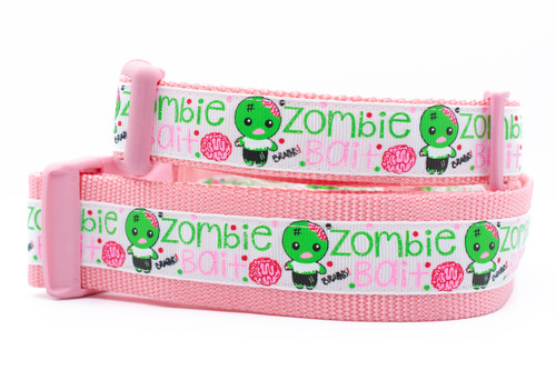 Pink collar with zombie and brains and words "Zombie bait".  Top is 1 inch wide and bottom is 1.5 inch wide.