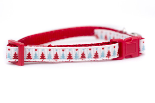 A cat collar with a blue and red Christmas tree pattern.