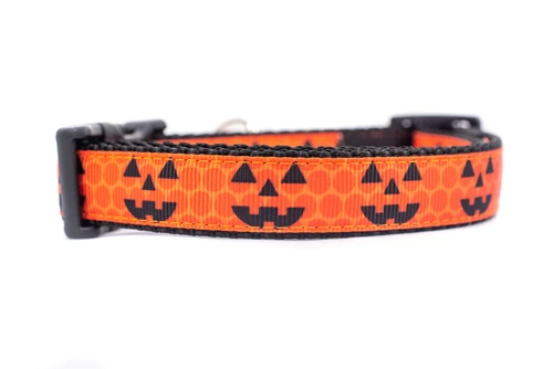 Jack o lantern face on a geometric print with orange background and black nylon.
