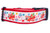 A red dog collar with a design includes a red airplane carrying presents, snowflakes, candy canes, and colorful ornaments.