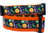A black and orange dog collar with a Halloween-themed print featuring pumpkins and  witches' hats.