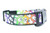 A black dog collar with white ghosts and a rainbow colored pattern. 