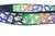 A black and white dog collar with a rainbow gradient and a pattern of white ghosts. 
