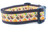A brown dog collar with a pale orange background and a pattern of turkeys, pilgrim hats, pumpkins, corn and leaves.