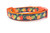 Orange dog collar with a pumpkin and leaf pattern.