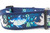 A blue dog collar with a colorful print of hammerhead sharks, rays and bubbles. 