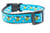 Glittery bees and daisies on a turquoise background.  Black nylon and matching black hardware.