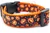 Smiling jack o' lanterns on a black polka dot background.  1 inch wide orange nylon.