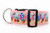 Flamingo Beach Holiday Dog Collar: A vibrant dog collar featuring a playful pattern of pink cartoon flamingos wearing Santa hats and scarves, surrounded by wrapped Christmas gifts and candy canes on a light blue background.