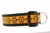 Halloween dog collar with glittery jack o lantern paws on orange background.