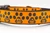 Halloween dog collar with glittery jack o lantern paws on orange background.