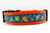 Multicolored fall leaves in brown, orange, lime and blue with swirls and dark blue background on an orange nylon.