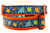Multicolored fall leaves in brown, orange, lime and blue with swirls and dark blue background on an orange nylon.