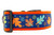 Multicolored fall leaves in brown, orange, lime and blue with swirls and dark blue background on an orange nylon.