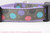 Black, blue, pink and purple sea shells on a dark grey background with lavender nylon.
