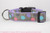 Black, blue, pink and purple sea shells on a dark grey background with lavender nylon.