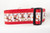 Red dog collar with a repeating pattern of reindeer wearing Santa hats. 