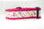 A pink dog collar with a white background and a floral pattern featuring leaves and flowers.