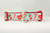 Holiday collar with a white and blue striped pattern with candy canes, red mugs and red coffee cups with snowflakes. 
