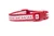 A red and white cat collar with a pattern of red reindeer and hearts. 
