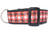 A black dog collar with a red and white plaid ribbon with gold glitter accents.