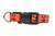 Jack o lantern face on a geometric print with orange background and black nylon.
