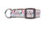 A white dog collar with a colorful print of owls and feathers.