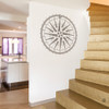 The Caspian Compass Wall Decal, shown here in brown vinyl color on a staircase wall. 