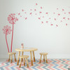 The Freya dandelion wall decal in dahlia red vinyl and placed in a kids playroom.