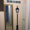 Customer photo of a black gas lamp wall decal with fleur-de-lys accent on an entryway wall.