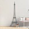 The Eiffel Tower wall decal shown here in dark grey color on an interior nursery room wall.