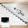 Rocket ship wall decal in a tv room, shown here in white dark grey color.