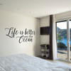 Wall decal quote of "Life is better on the ocean." Shown here in the black vinyl color.