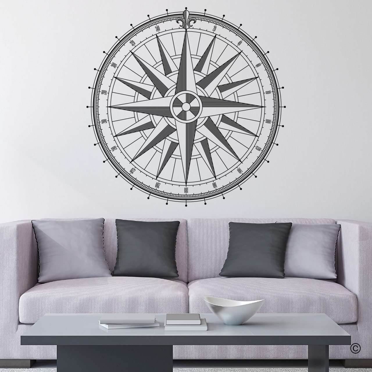 The Caspian Compass Wall Decal, shown here in black vinyl color on a living room wall. 