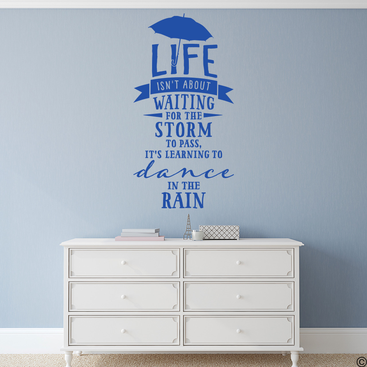 Wall quote "Life isn't about waiting for the storm to pass, it's learning to dance in the rain," vinyl wall decal in traffic blue