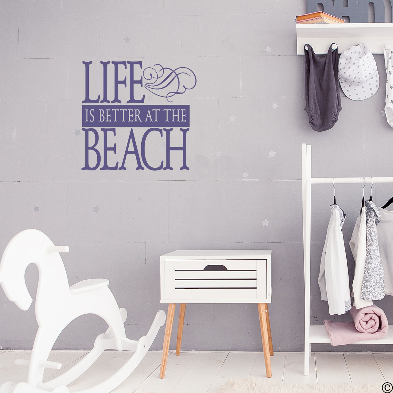 Life is better at the Beach wall decal on a wall in the limited edition orchid vinyl color.