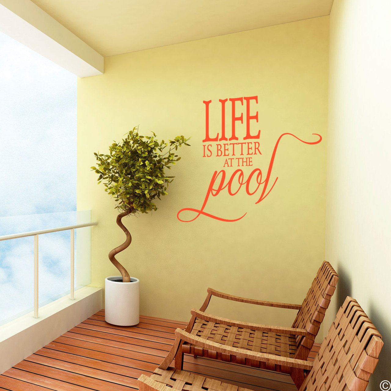 The Life is better at the Pool wall decal, on a balcony wall in the orange vinyl color.