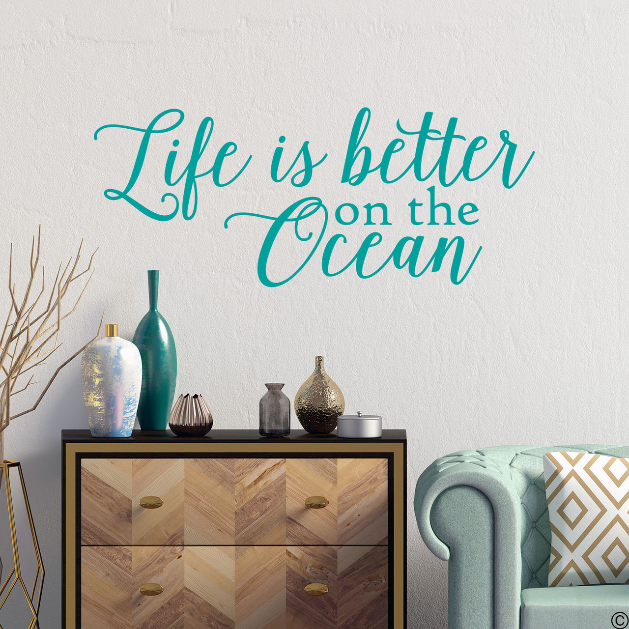 Wall decal quote of "Life is better on the ocean." Shown here in the turquoise vinyl color.