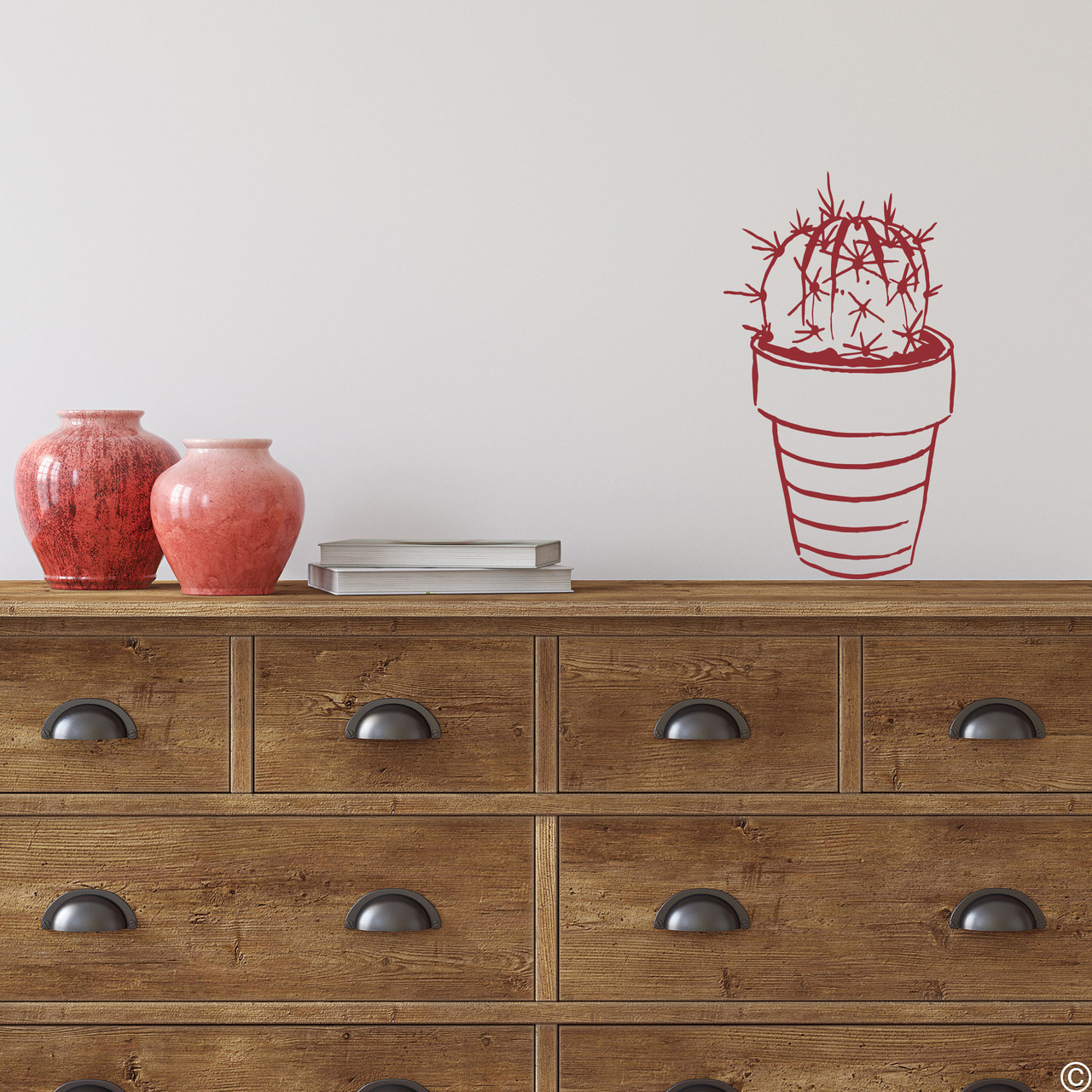 The hand drawn potted cactus wall decal in dark red vinyl color.