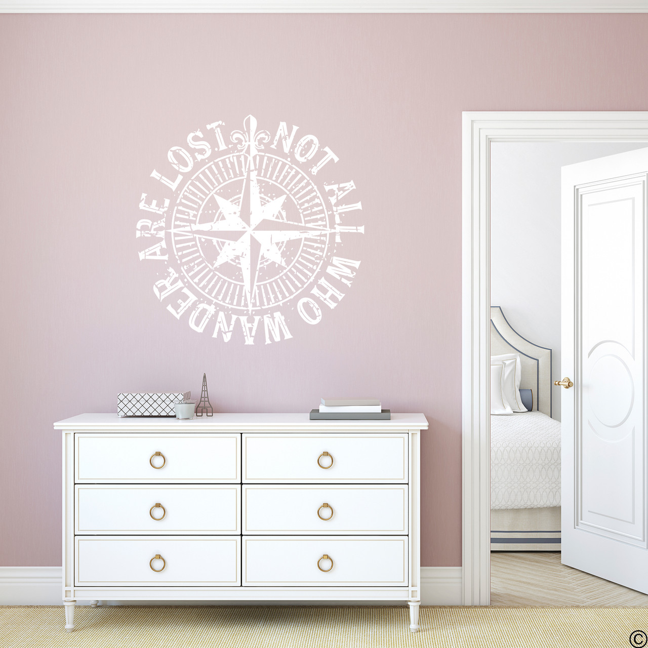 The "Not all who wander are lost" distressed compass rose wall decal shown here in white vinyl.