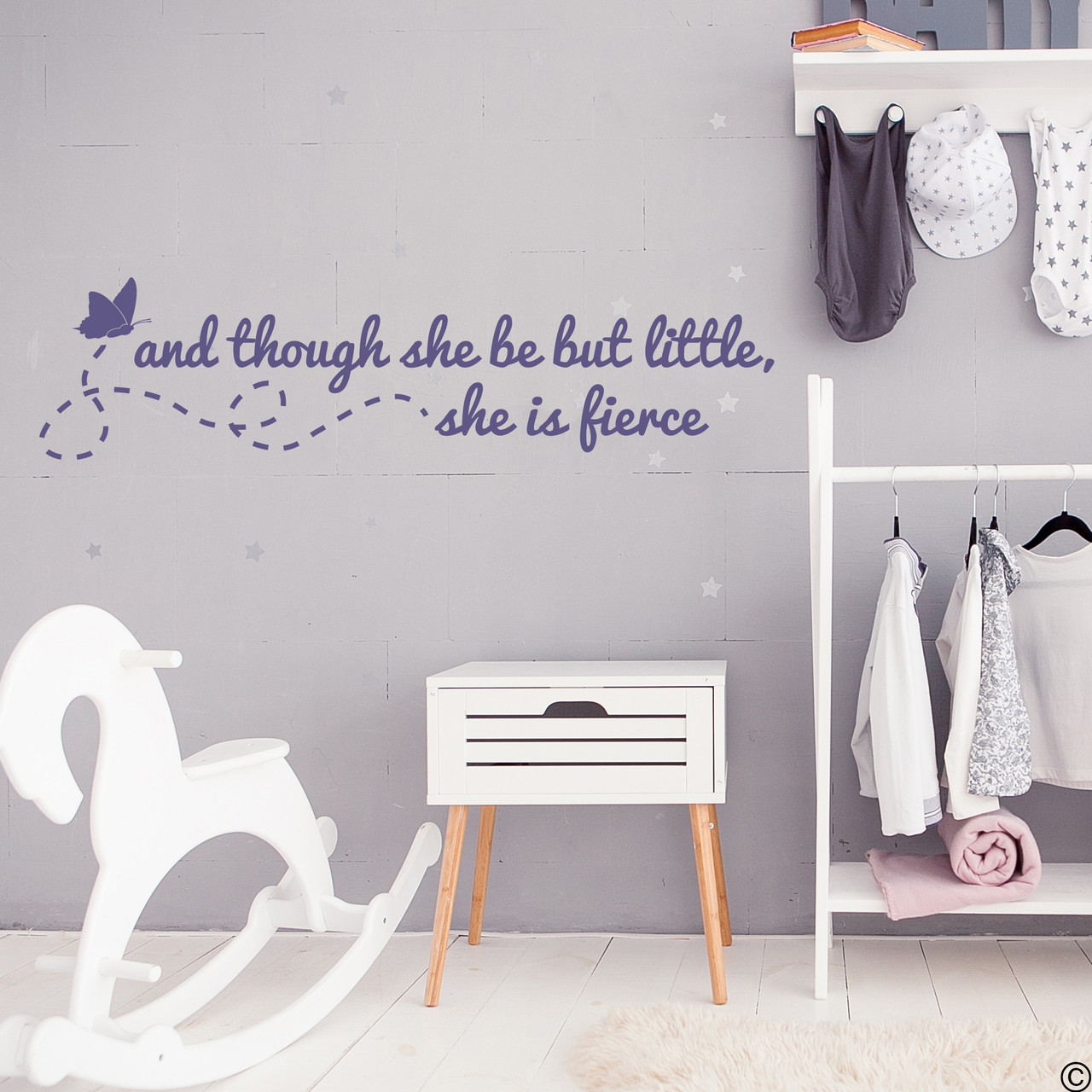 Flying butterfly with a Shakespeare wall decal quote of "and though she be but little, she is fierce." Applied here to a girl's bedroom wall in the limited edition orchid vinyl color.