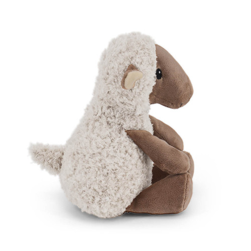 A soft, plush toy shaped like a sheep. The sheep is sitting in a three-quarter profile, looking to the left. Its fuzzy white body, tan face, and small, curled tail are visible.