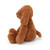 A soft, plush toy shaped like a brown dog. The dog is sitting in a three-quarter profile, looking to the left. Its long, floppy ears and small tail are visible.