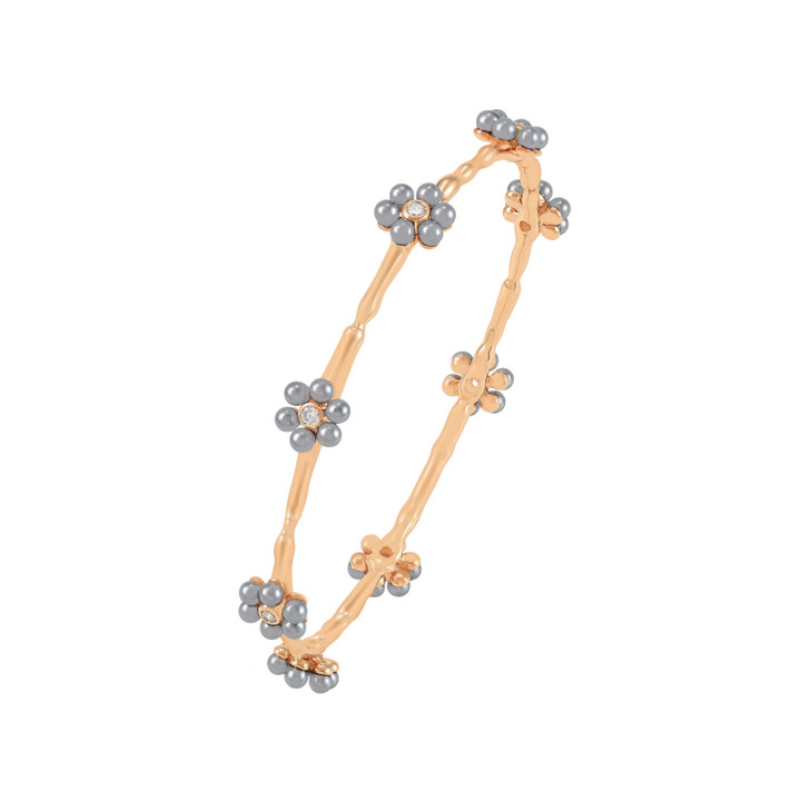 Gold bangle bracelet decorated with grey pearl daisy flowers and crystal centers.