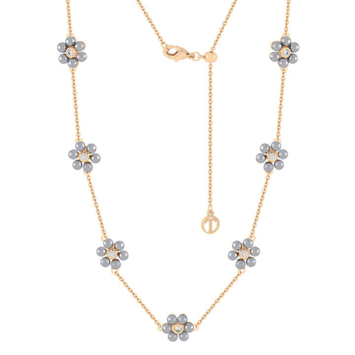 Gold chain necklace featuring seven daisy-shaped charms with grey pearls and crystal centers, adjustable clasp with signature charm.