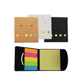 Three sticky note pads in brown, white, and black holders, featuring vibrant coloured sticky notes inside.