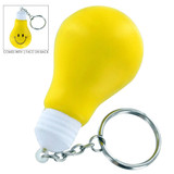 A yellow light bulb-shaped stress key ring with a smiley face on one side and a silver keychain attachment.